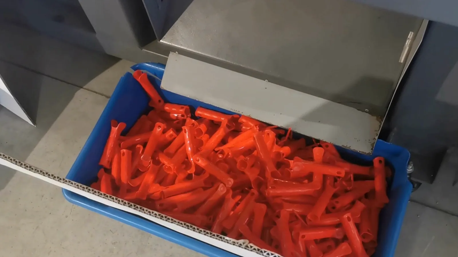 Finished plastic parts in a crate after moulding
